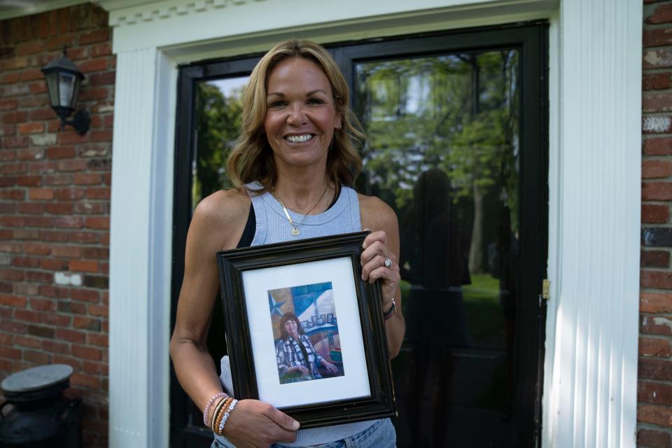 Amy Dinwiddie holds a photo of her mother, Susan Jordan on Wednesday, May 10, 2023 at at their home in Indianapolis. 