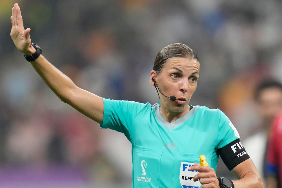 Referee Stephanie Frappart holds her arm up during the World Cup group E soccer match between Costa Rica and Germany at the Al Bayt Stadium in Al Khor, Qatar, Thursday, Dec.1, 2022. (AP Photo/Moises Castillo)