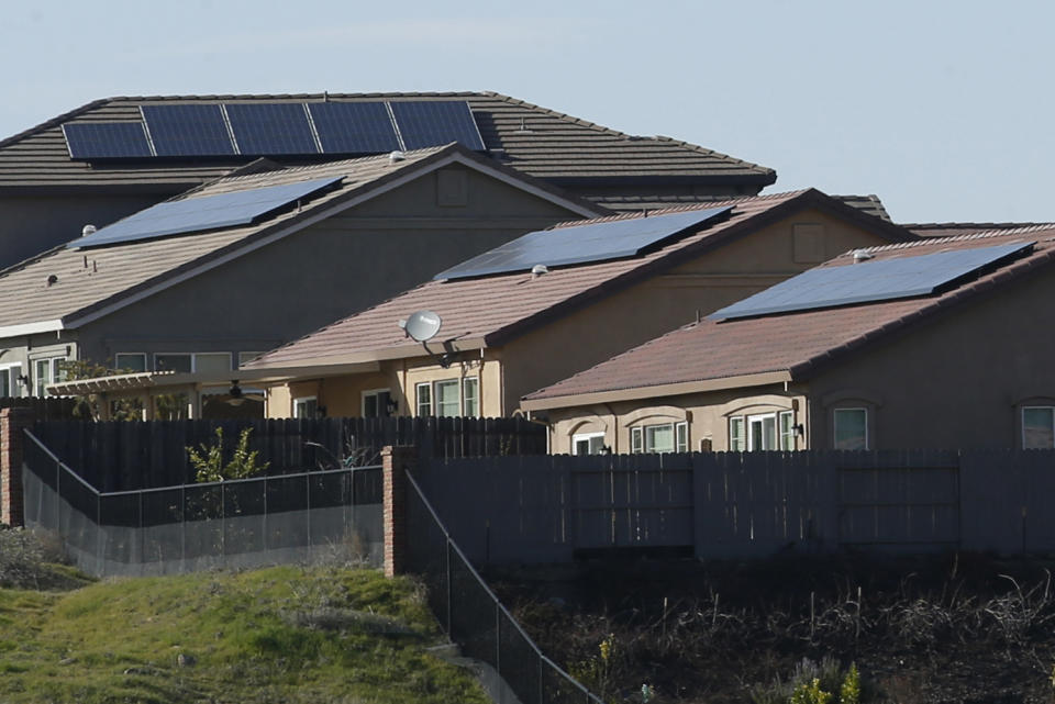 FILE - Solar panels on rooftops of a housing development in Folsom, Calif., on Feb. 12, 2020. California utility regulators will consider a proposal on Thursday, Dec. 15, 2022, to remake financial incentives for people who install rooftop solar panels on their homes. (AP Photo/Rich Pedroncelli, File)