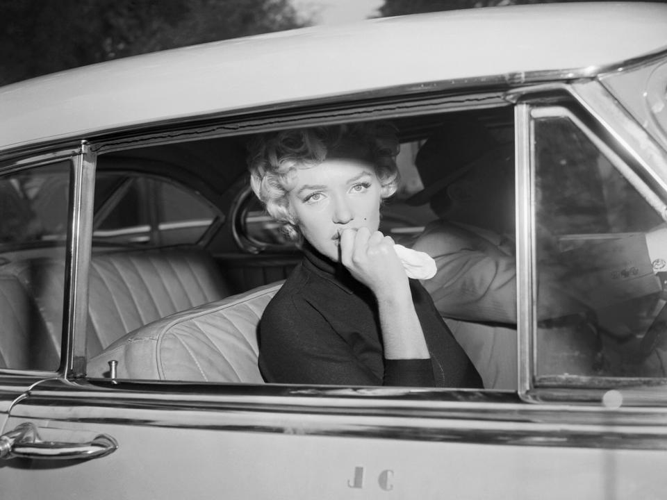 Marilyn Monroe leaves the home she briefly shared with Joe Di Maggio in a car driven by her attorney, Jerry Giesler. Monroe had just announced her intent to divorce Di Maggio on grounds of "mental cruelty"