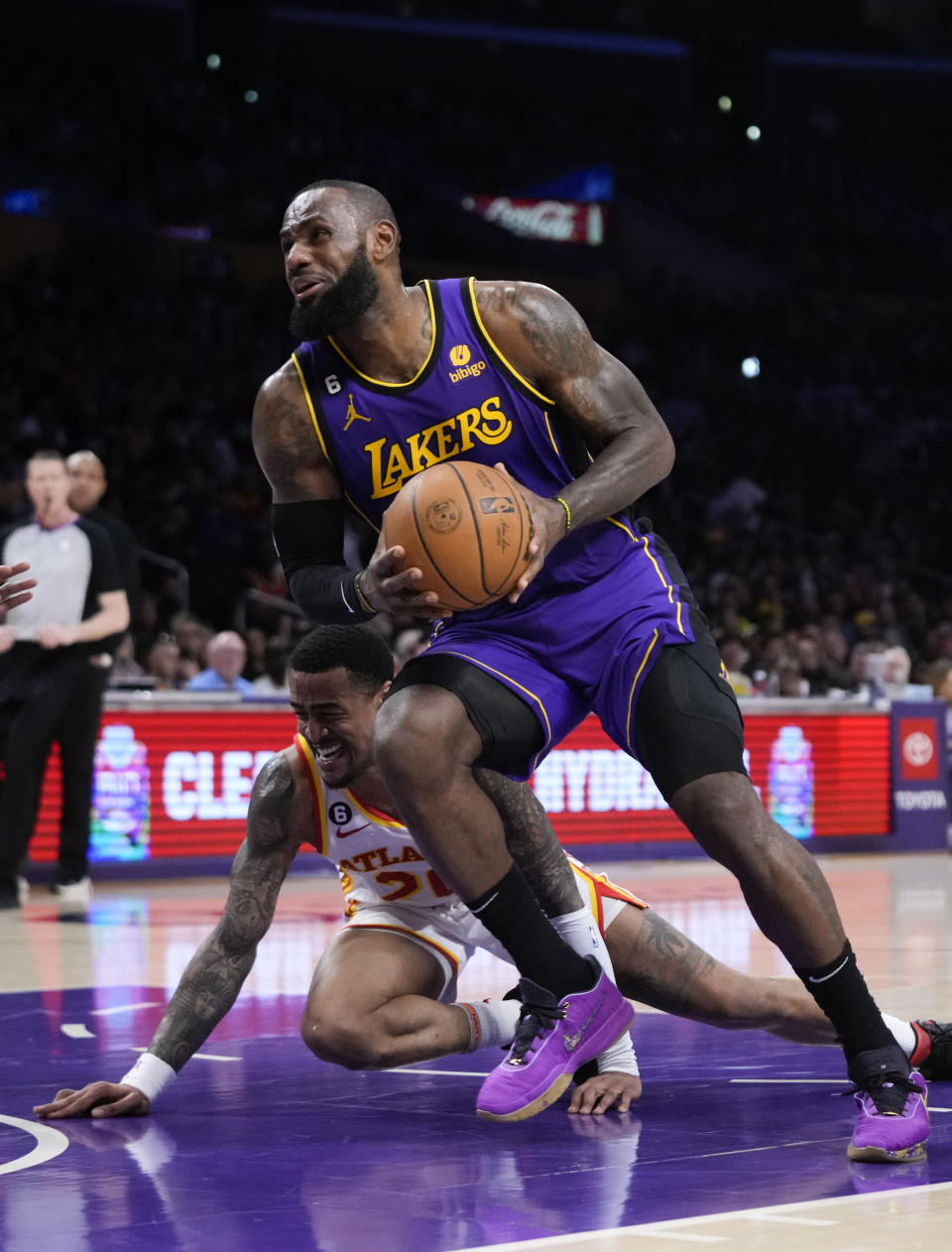 Los Angeles Lakers' LeBron James drives to the basket past Atlanta Hawks' John Collins during the first half of an NBA basketball game Friday, Jan. 6, 2023, in Los Angeles. (AP Photo/Jae C. Hong)