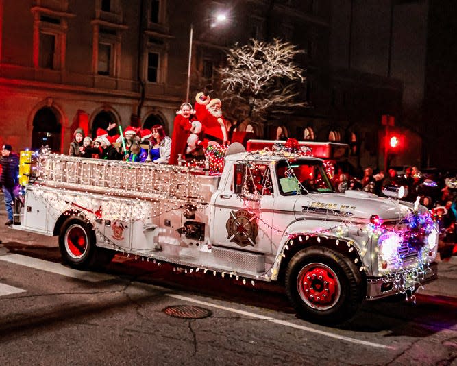 Puebloans participate atop a vehicle decorated with lights during the 2022 Pueblo Parade of Lights.