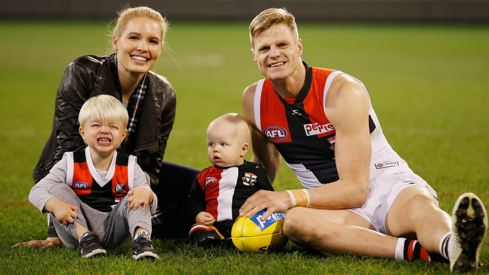 MELBOURNE, AUSTRALIA – AUGUST 27: Nick Riewoldt sits on the M.C.G. with his wife Catherine and sons James and William after playing his final game the round 23 AFL match between the Richmond Tigers and the St Kilda Saints at Melbourne Cricket Ground on August 27, 2017 in Melbourne, Australia. (Photo by Darrian Traynor/Getty Images)