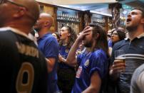 Leicester City fans react during their team's soccer match against Manchester United, as they watch the match on television in the Hogarth's pub in Leicester, Britain May 1, 2016 REUTERS/Eddie Keogh