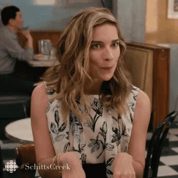 Alexis from "Schitt's Creek" acting very excited.