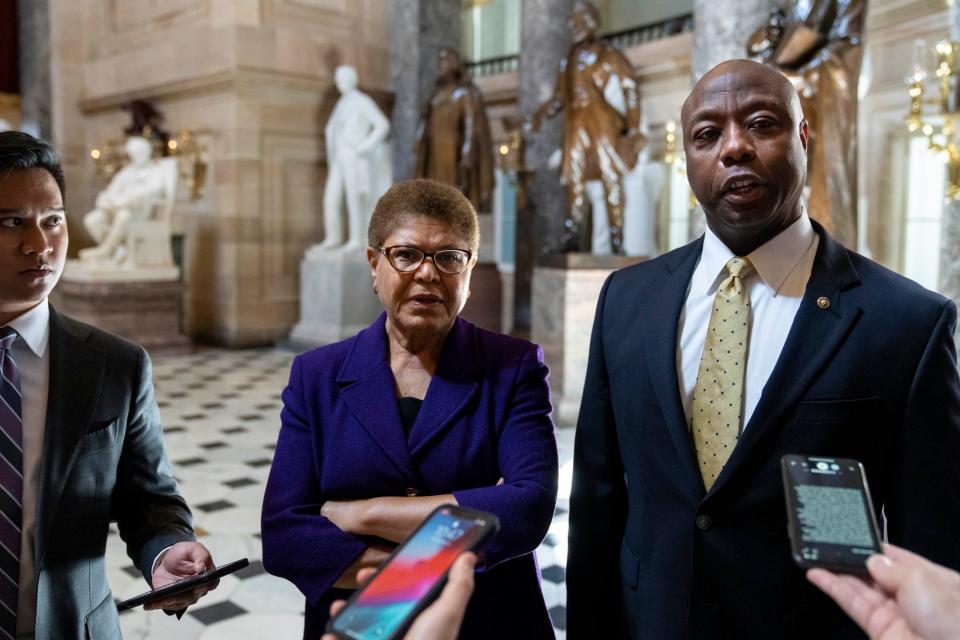 WASHINGTON, DC - MAY 18: (L-R) Rep. Karen Bass (D-CA) and Sen. Tim Scott (R-SC) speak briefly to reporters as they exit the office of Rep. James Clyburn (D-SC) following a meeting about police reform legislation on Capitol Hill May 18, 2021 in Washington, DC. President Joe Biden has called for Congress to pass a police reform bill by the May 25th anniversary of the killing of George Floyd by  Minneapolis Police officer Derek Chauvin. Lawmakers are still discussing key provisions in the bill, including qualified immunity laws for law enforcement officers. (Photo by Drew Angerer/Getty Images)