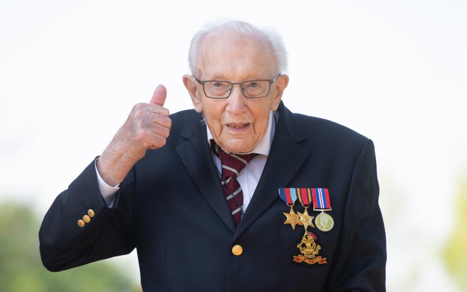 File photo dated 16/04/20 of Captain Tom Moore, at his home in Marston Moretaine, Bedfordshire, who is to be knighted by the Queen in his own unique personal open-air ceremony at Windsor Castle on Friday. PA Photo. Issue date: Wednesday July 15, 2020. The 100-year-old Second World War veteran will travel to the historic Berkshire royal residence with members of his family for the special outdoor investiture. See PA story ROYAL Moore. Photo credit should read: Joe Giddens/PA Wire - Joe Giddens/PA Wire