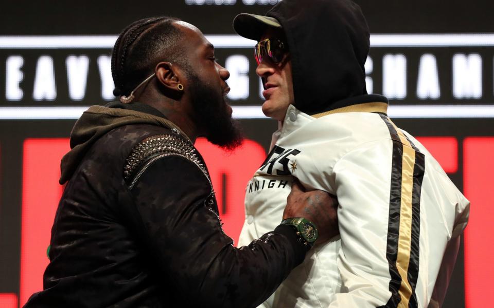 Deontay Wilder and Tyson Fury confront each other on stage during the press conference at the MGM Grand Garden Arena - PA