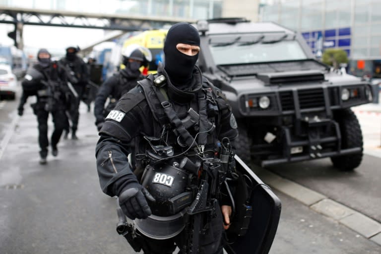 RAID police unit officers secure the area at the Paris' Orly airport on March 18, 2017 following the shooting of a man by French security forces