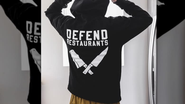 skier wearing defend restaurants sweatshirt