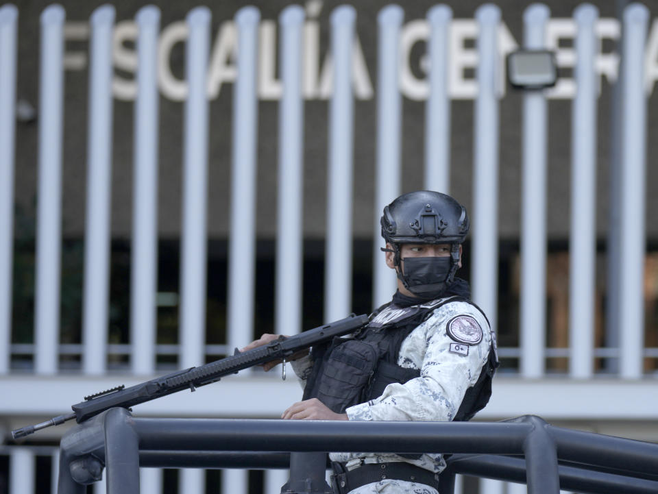 Security personnel guard the prosecutor's building where Ovidio Guzmán, one of the sons of former Sinaloa cartel boss Joaquin "El Chapo" Guzmán, is in custody in Mexico City, Thursday, Jan. 5, 2023. The Mexican military has captured Ovidio Guzman during a operation outside Culiacan, a stronghold of the Sinaloa drug cartel in western Mexico. (AP Photo/Fernando Llano)