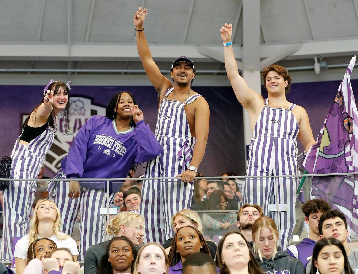 Members of the Frog Army do the Horned Frog hand salute during the CFP national championship football game watch party at Schollmeier Arena, in Fort Worth, Texas, Monday, Jan. 9, 2023.