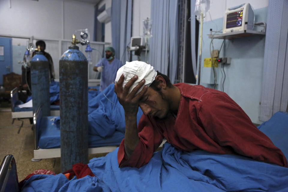 An injured man receives treatment at a hospital after a suicide bombing in Kabul, Afghanistan, Nov. 20, 2018. Afghan officials said the suicide bomber targeted a gathering of Muslim religious scholars in Kabul, killing tens of people. A Public Health Ministry spokesman said another 60 people were wounded in the attack, which took place as Muslims around the world marked the birthday of the Prophet Mohammad. (AP Photo/Rahmat Gul)