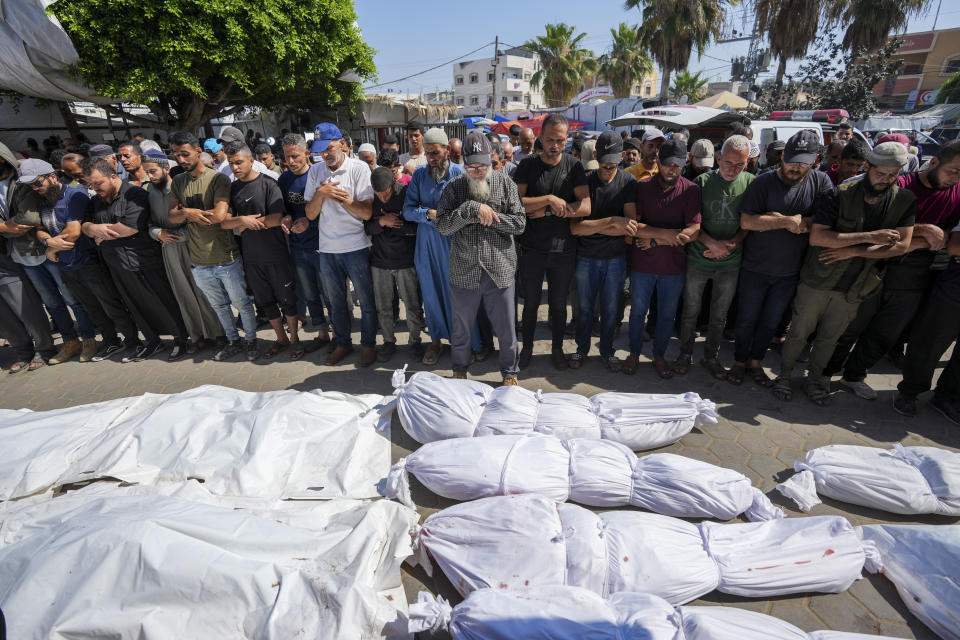 Palestinians mourn relatives killed in an Israeli strike on Israeli strike on a U.N.-run school in the Nusseirat refugee camp, outside a hospital in Deir al Balah, Gaza Strip, Thursday, June 6, 2024. (AP Photo/Abdel Kareem Hana)