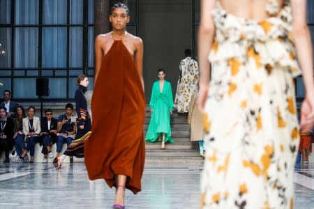 Models present creations during the Victoria Beckham catwalk show at London Fashion Week in London