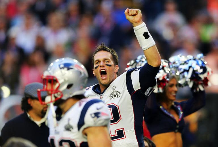 Tom Brady of the New England Patriots runs on the field prior to Super Bowl XLIX at University of Phoenix Stadium on February 1, 2015