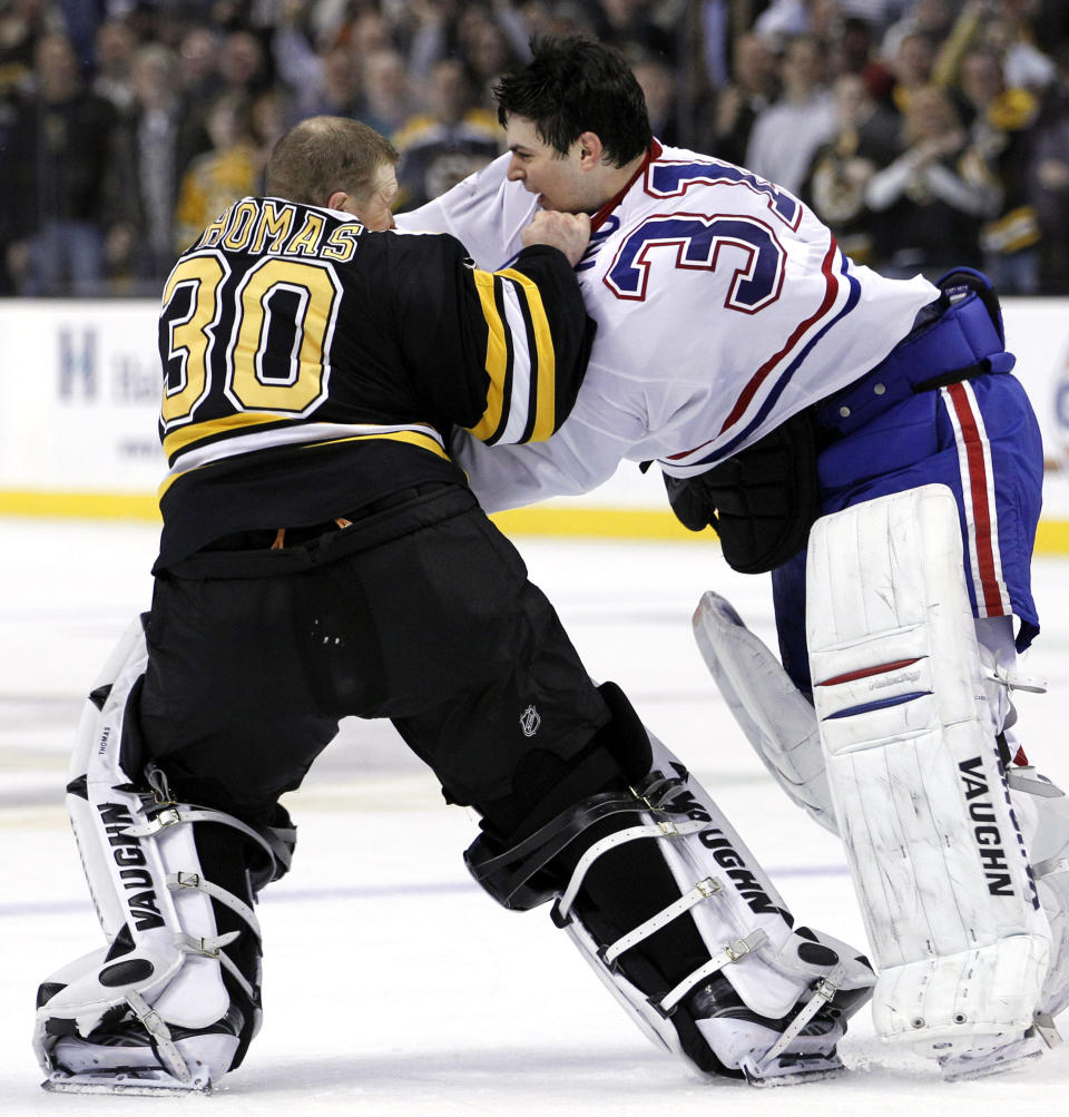 FILE - Montreal Canadiens goalie Carey Price (31) fights with Boston Bruins goalie Tim Thomas (30) during the second period of an NHL hockey game in Boston, Feb. 9, 2011. The league rule changes have made it so punitive that goalie fighting has essentially disappeared from the highest level of hockey. (AP Photo/Elise Amendola, File)