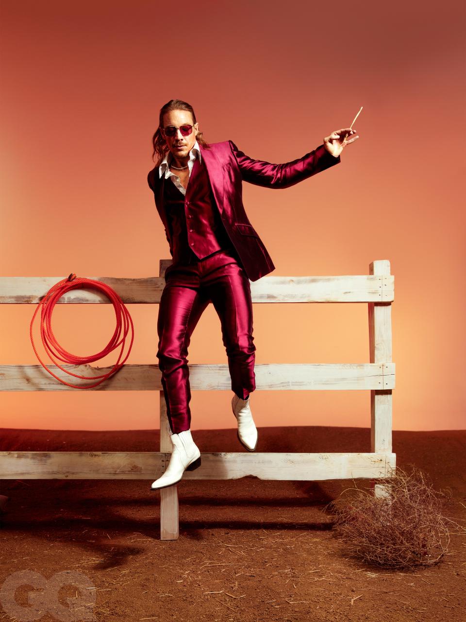 <cite class="credit">Suit, $4,395, and shirt, $1,195, by Dolce & Gabbana / Boots, $378, by Matt Shultz x Frye / Sunglasses, $310, by Persol / Necklace, $67,200, by Shay</cite>