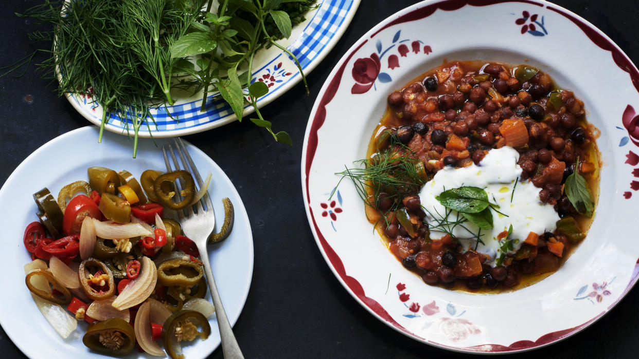  A bowl of spice beans topped with yoghurt and herbs. 