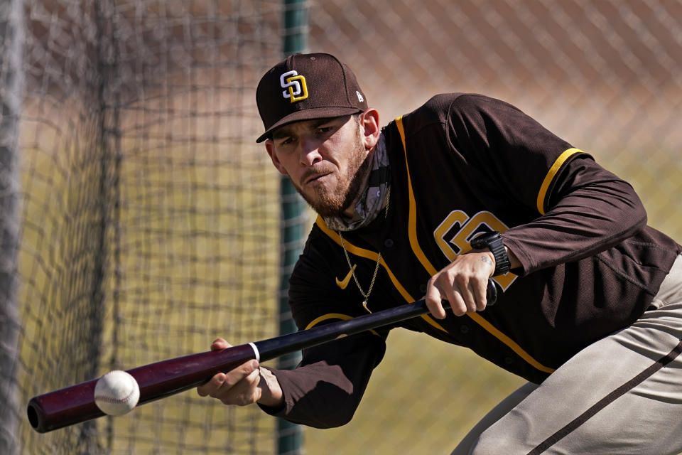 San Diego Padres' Joe Musgrove bunts during spring training baseball practice Tuesday, Feb. 23, 2021, in Peoria, Ariz. (AP Photo/Charlie Riedel)