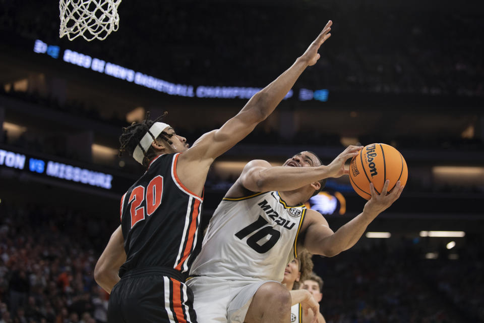Princeton forward Tosan Evbuomwan (20) defends against Missouri guard Nick Honor (10) during the second half of a second-round college basketball game in the men's NCAA Tournament, Saturday, March 18, 2023, in Sacramento, Calif. Princeton won 78-63. (AP Photo/José Luis Villegas)