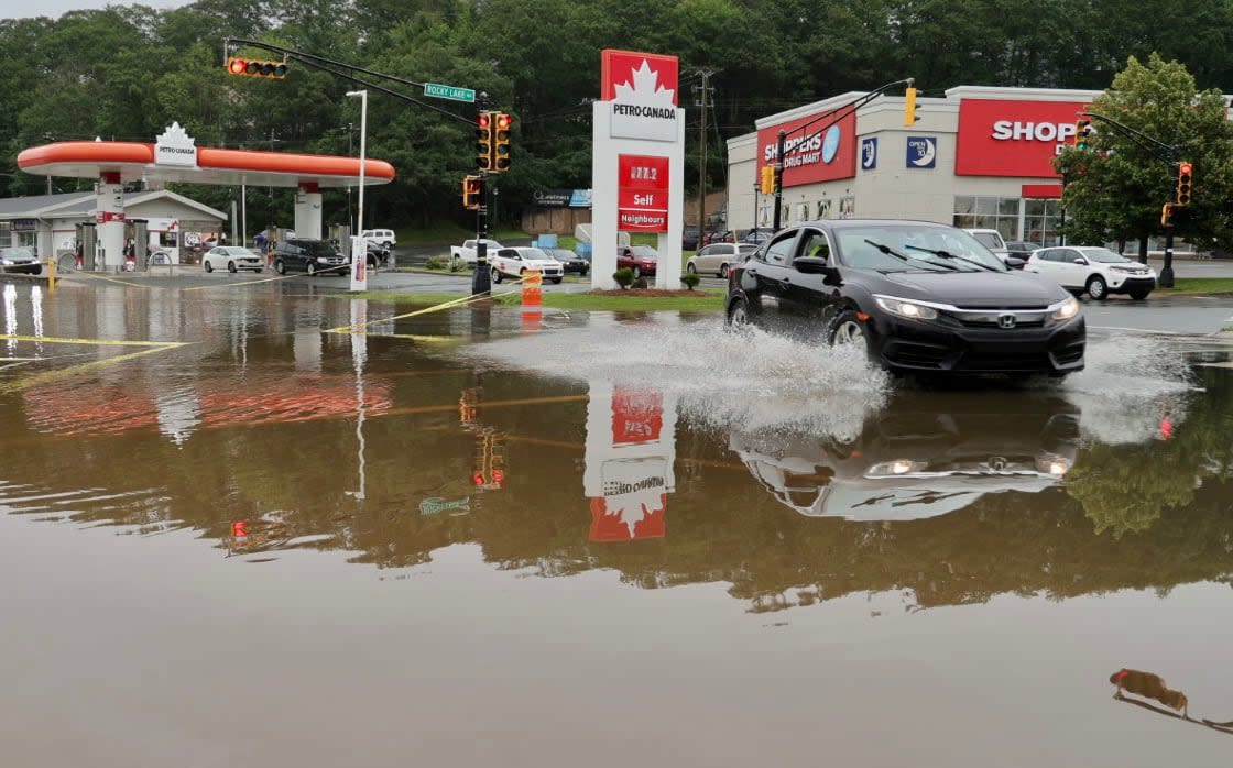 A car drives through a flooded street in Bedford, N.S., following major rainfall in July 2023.  (Jeorge Sadi/CBC - image credit)