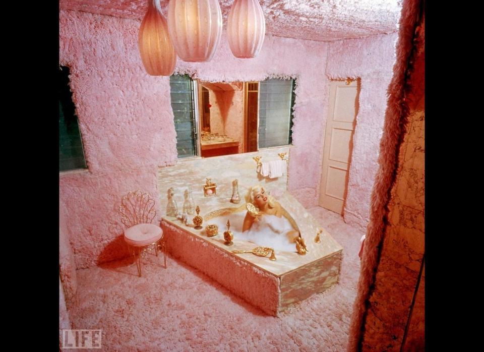 Jayne Mansfield takes a bath in her carpeted pink bathroom, also known as 'The Pink Palace', at her Los Angeles home in 1960.