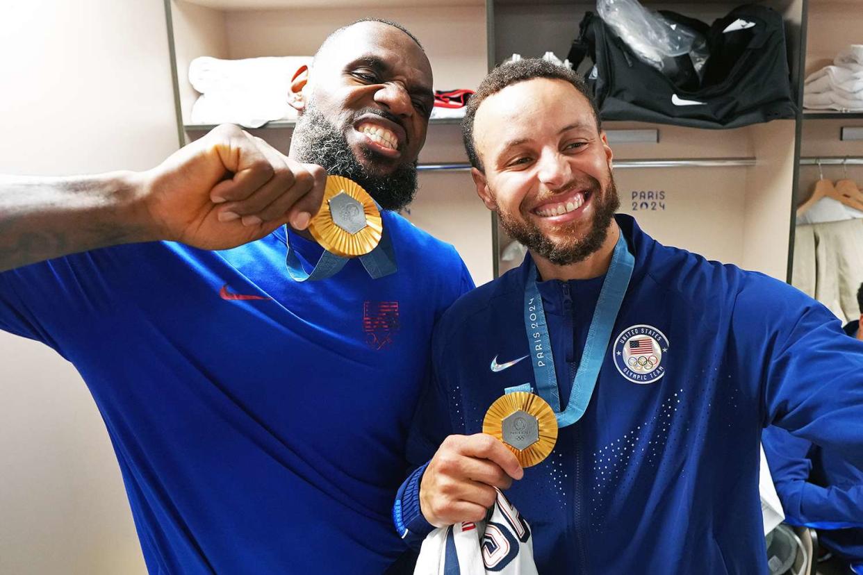 <p>Jesse D. Garrabrant/NBAE/Getty</p> LeBron James and Stephen Curry pose with their Olympic gold medals at the 2024 Paris Games