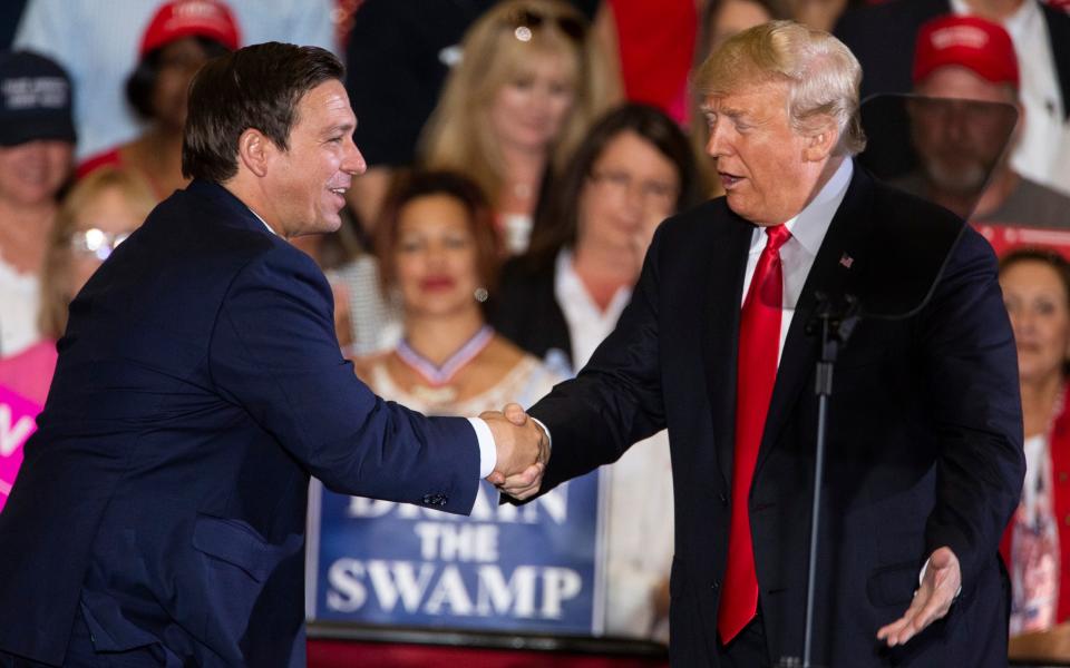 Donald Trump welcomes Ron DeSantis during a campaign rally at the Pensacola International Airport on November 3, 2018 - Mark Wallheiser