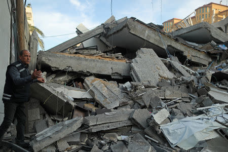 A Palestinian man gestures as he stands at the remains of a building that was destroyed in Israeli air strikes, in Gaza City May 5, 2019. REUTERS/Suhaib Salem