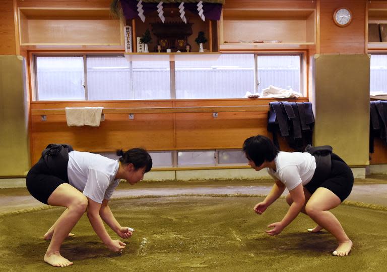 Female sumo wrestlers Sayaka Matsuo (R) faces off during a training session against Shiori Kanehira, two of a relatively small number of female grapplers compared to their male counterparts