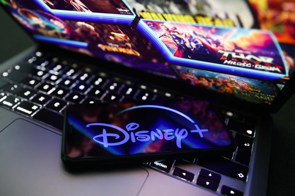 Disney+ logo displayed on a phone screen and Disney+ website displayed on a laptop screen are seen in this illustration photo taken in Krakow, Poland on November 27, 2022.