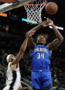Orlando Magic's Wendell Carter, Jr. (34) shoots against San Antonio Spurs' Derrick White during the first half of an NBA basketball game Wednesday, Oct. 20, 2021, in San Antonio. (AP Photo/Darren Abate)