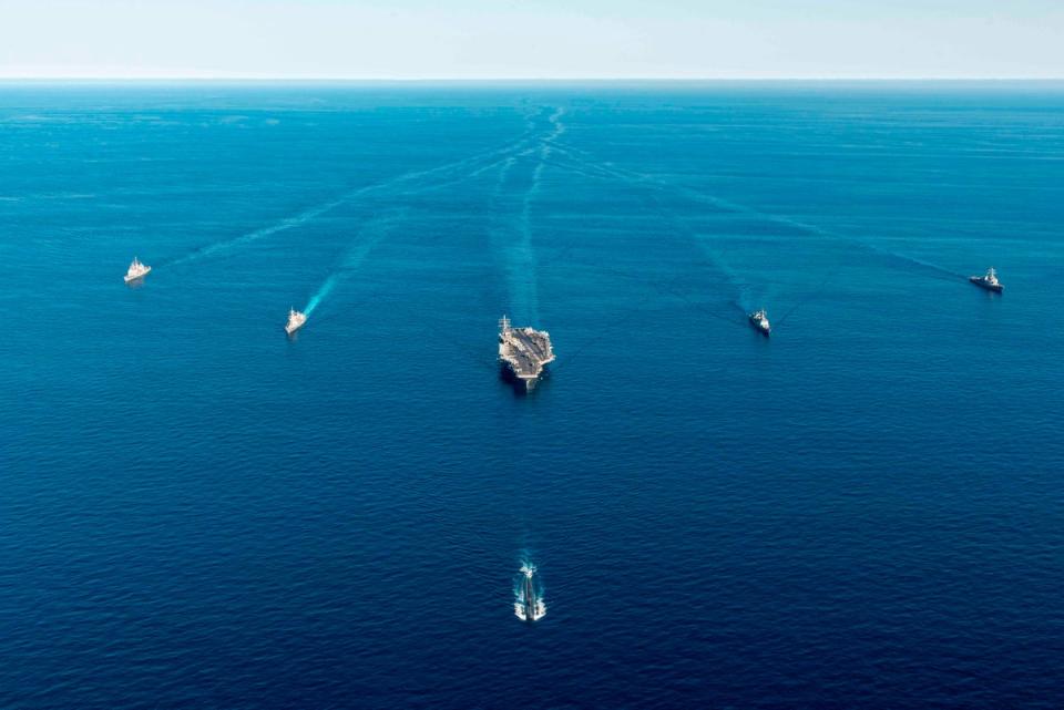 The USS Ronald Reagan aircraft carrier, center, participates in a joint anti-submarine drill among South Korea, the United States and Japan (AP)