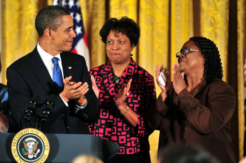 President Barack Obama (L) claps with Louvon Harris (C) and Betty Byrd Boatner, the sisters of James Byrd, Jr., who was a victim of a hate crime, as he delivers remarks on the passing of the Matthew Shepard Hate Crimes Prevention Act, at the White House in Washington on October 28, 2009. On June 7, 1998, three white supremacists killed Byrd by dragging him for 3 miles behind a pickup truck in Jasper, Texas. File Photo by Kevin Dietsch/UPI