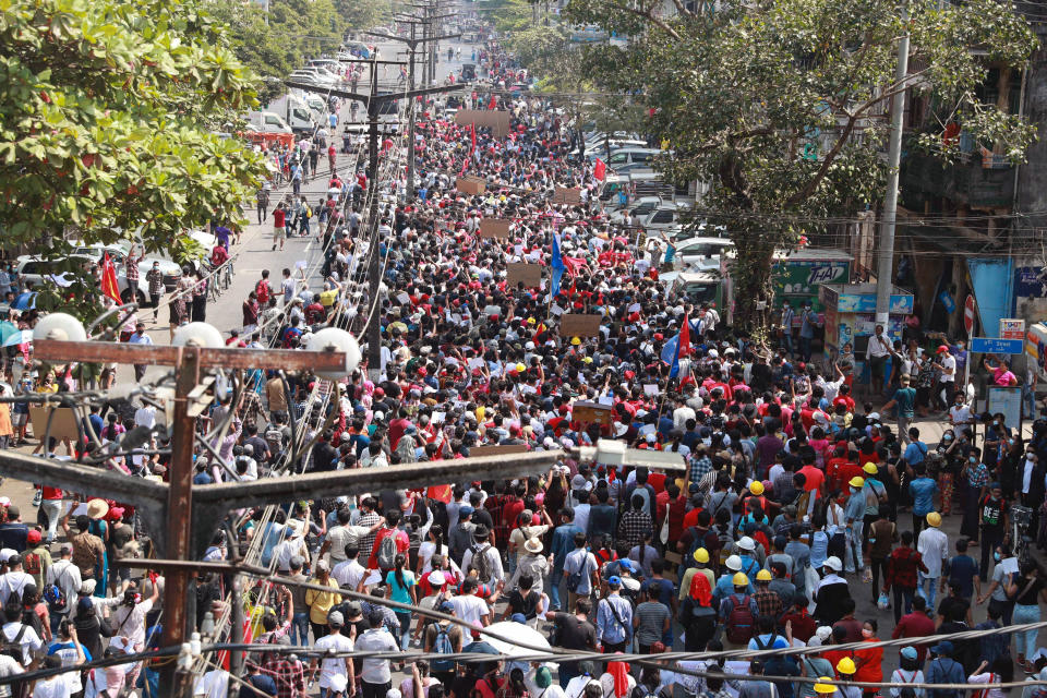 Protesters march towards the direction of Sule Pagoda in Yangon, Myanmar on Sunday, Feb. 7, 2021. Thousands of people rallied against the military takeover in Myanmar's biggest city on Sunday and demanded the release of Aung San Suu Kyi, whose elected government was toppled by the army that also imposed an internet blackout. (AP Photo)