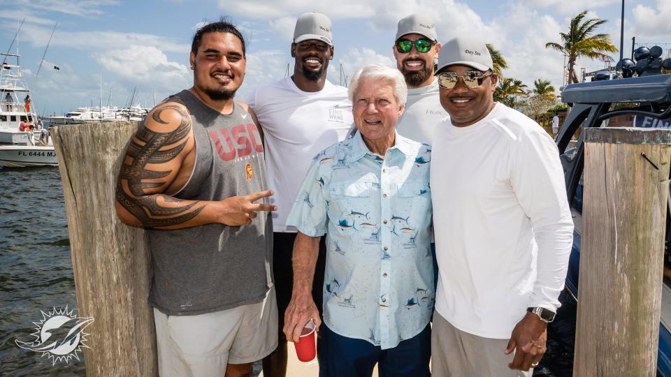 Jimmy Johnson is surrounded by present Dolphins players Brandon Pili, Cameron Brown and Zach Sieler and alumni Shawn Wooden during Fins Weekend on June 1 at the Grove Harbour Marina in Coconut Grove.