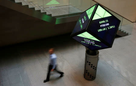 FILE PHOTO: A man walks through the lobby of the London Stock Exchange in London, Britain August 25, 2015. REUTERS/Suzanne Plunkett/File Photo