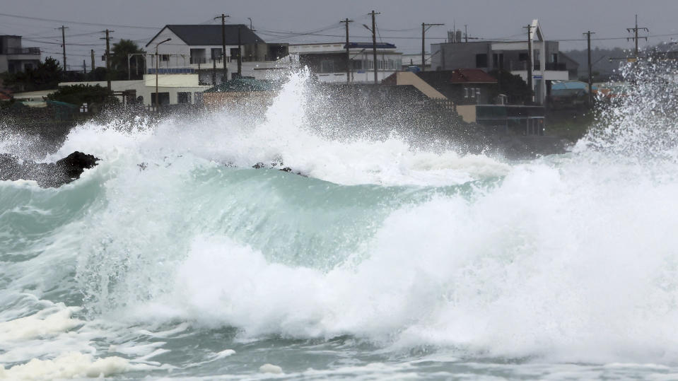 High waves crash a shore as the tropical storm named Khanun approaches to the Korean Peninsular, on Jeju Island, South Korea, Wednesday, Aug. 9, 2023. Dozens of flights and ferry services were grounded in South Korea on Wednesday ahead of the tropical storm that has dumped heavy rain on Japan's southwestern islands for more than a week. (Park Ji-ho/Yonhap via AP)