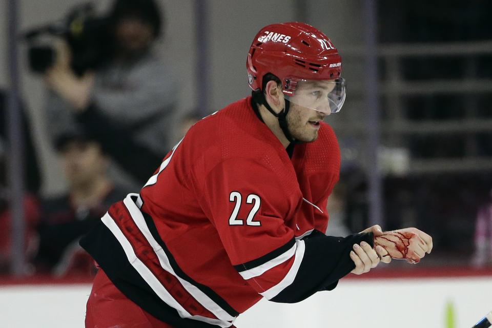 Carolina Hurricanes defenseman Brett Pesce (22) skates away following an injury during the second period of an NHL hockey game against the Vancouver Canucks in Raleigh, N.C., Sunday, Feb. 2, 2020. (AP Photo/Gerry Broome)