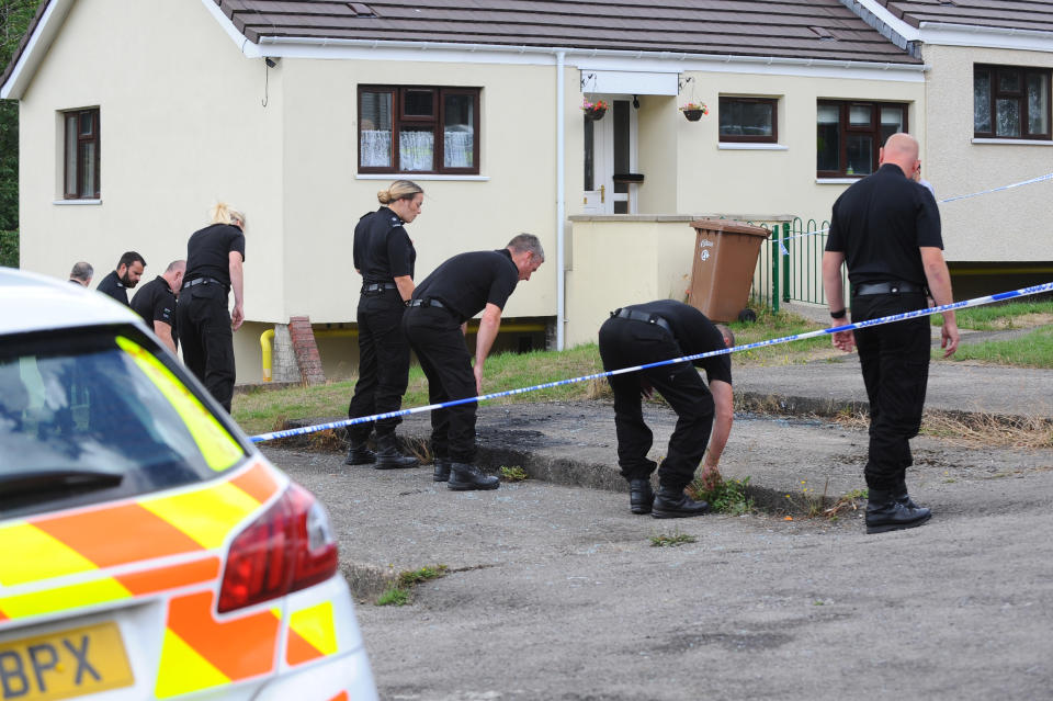 Police search for clues after the murder last August (Wales News Service)