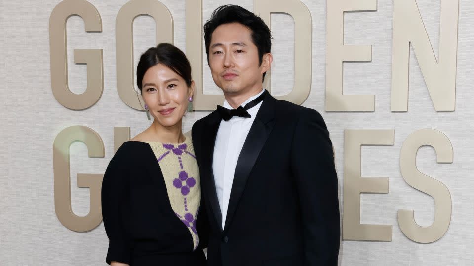“Beef” actor Steven Yeun and his wife Joana Pak look elegant in understated black numbers. - Robert Gauthier/Los Angeles Times/Getty Images