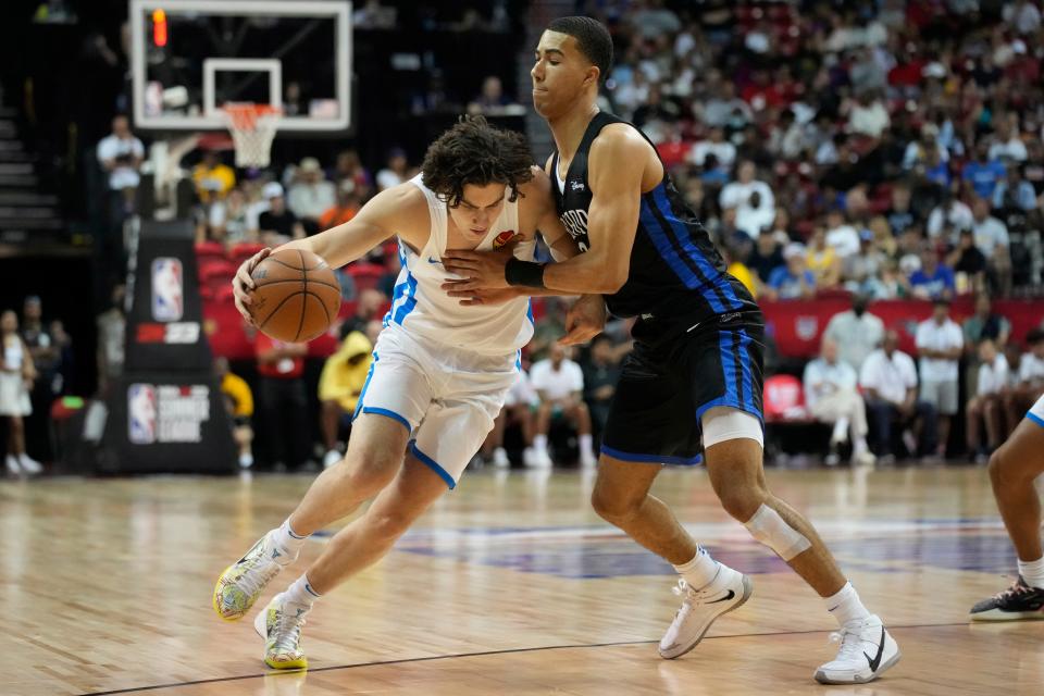 Oklahoma City's Josh Giddey, left, drives around Orlando's Caleb Houston during the first half of Monday's NBA Summer League game in Las Vegas.