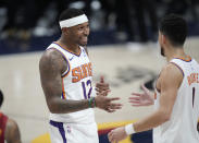 Phoenix Suns forward Torrey Craig, left, congratulates guard Devin Booker as time runs out in the second half of Game 4 of an NBA second-round playoff series against the Denver Nuggets, Sunday, June 13, 2021, in Denver. Phoenix won 125-118 to sweep the series. (AP Photo/David Zalubowski)