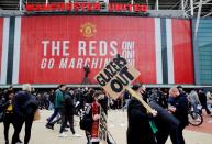 Manchester United fans protest against their owners before the Manchester United v Liverpool Premier League match