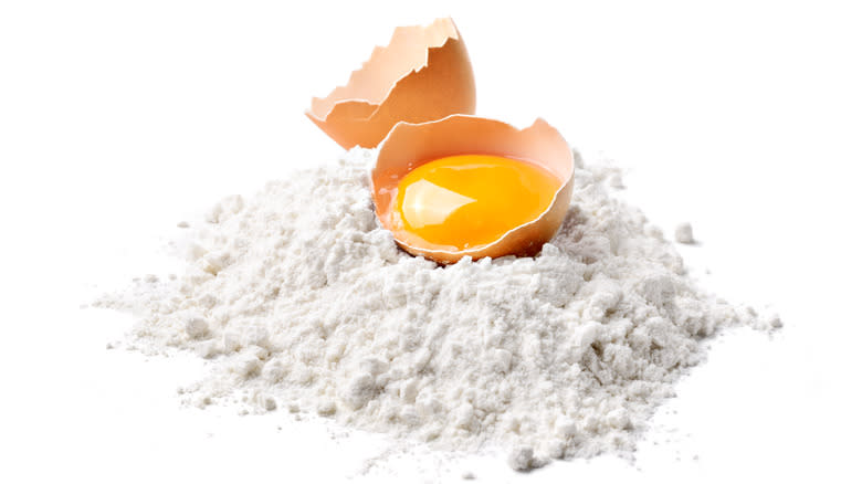 broken eggs on flour pile