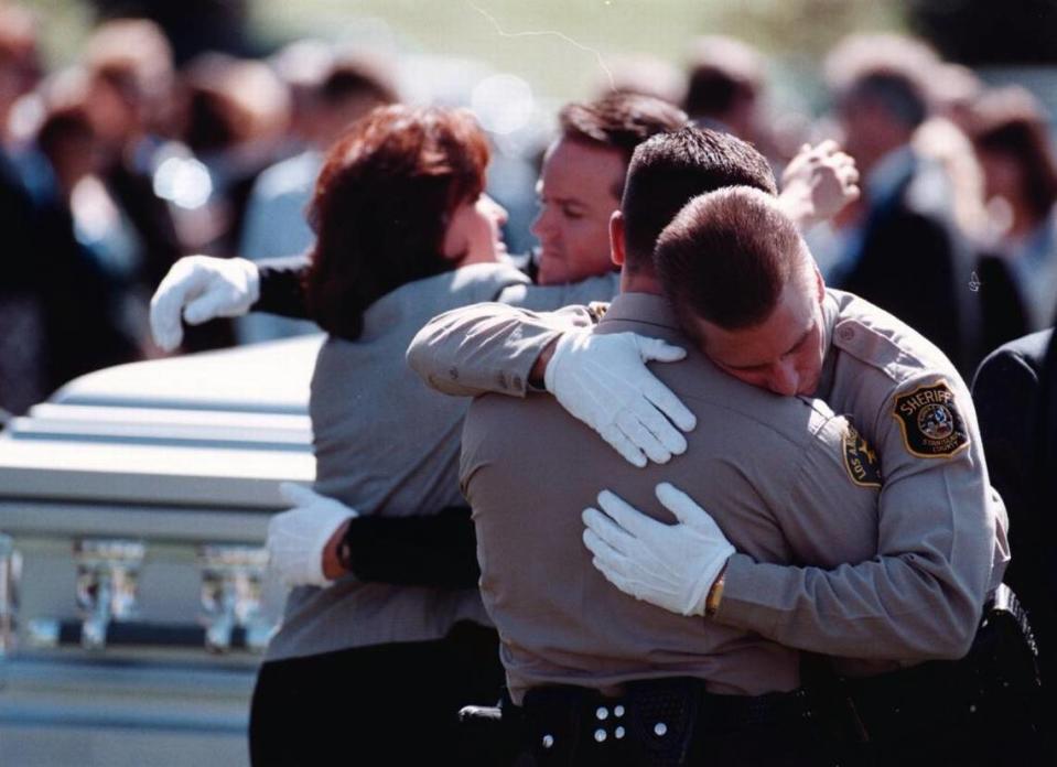 Pallbearers from the Los Angeles County Sheriff’s Department hug in front of Boise police officer Mark Stall’s casket.