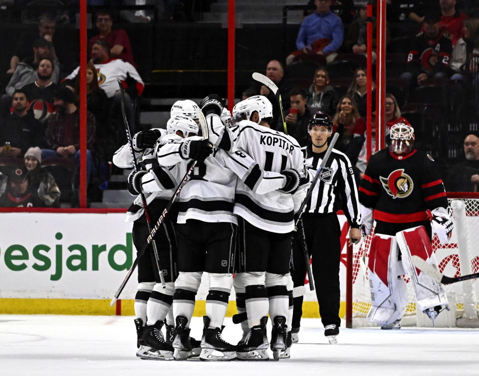 Los Angeles Kings players surround left wing Kevin Fiala after his goal on Ottawa Senators goaltender Cam Talbot during the second period of an NHL hockey game, Tuesday, Dec. 6, 2022, in Ottawa, Ontario. (Justin Tang/The Canadian Press via AP)