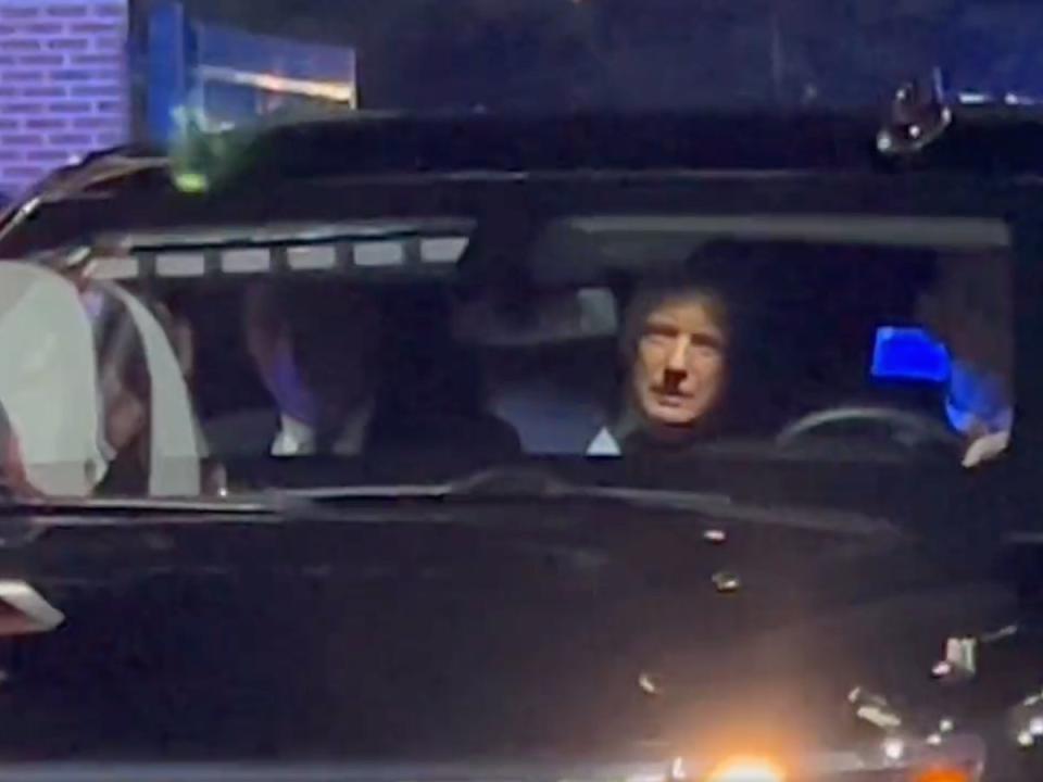 Donald Trump peers out of his vehicle as he is booed by college football fans at Williams-Brice Stadium in South Carolina ahead of the Palmetto Bowl (screengrab/@BMeiselas/Twitter)