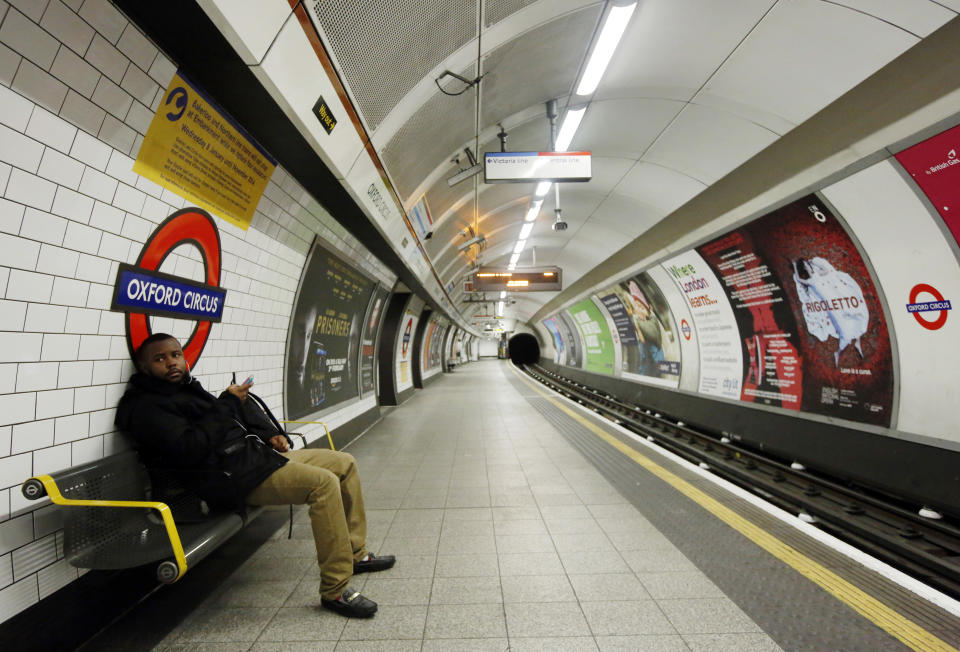 A passenger waits for a tube train that did not arrive on an empty platform during rush hour at Oxford Circus underground station in London February 5, 2014. Millions of commuters in London faced travel chaos on Wednesday on the first full day of a 48-hour tube strike by London Underground staff over planned job cuts and the closure of ticket offices. REUTERS/Luke MacGregor  (BRITAIN - Tags: BUSINESS EMPLOYMENT TRANSPORT CIVIL UNREST)